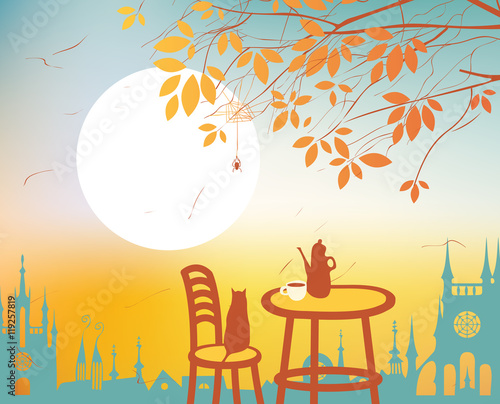 Urban autumn landscape with a street cafe on the background of the old town