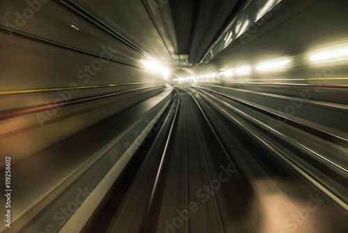 Fast underground train riding in a tunnel of the modern city