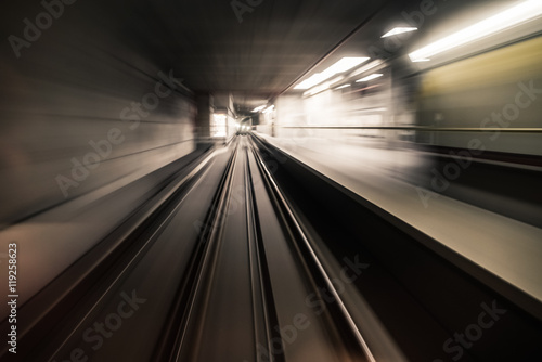 Fast underground train riding in a tunnel of the modern city