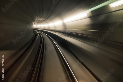 Fast underground train riding in a tunnel of the modern city