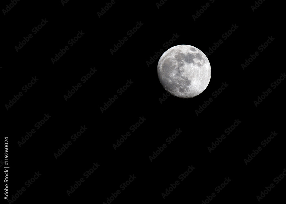 Full moon over dark black sky at night Full moon over dark black sky at night
