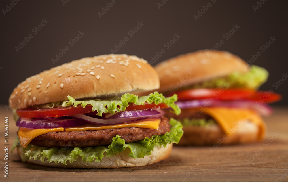 Fresh burgers on wooden background Fresh burgers on wooden background