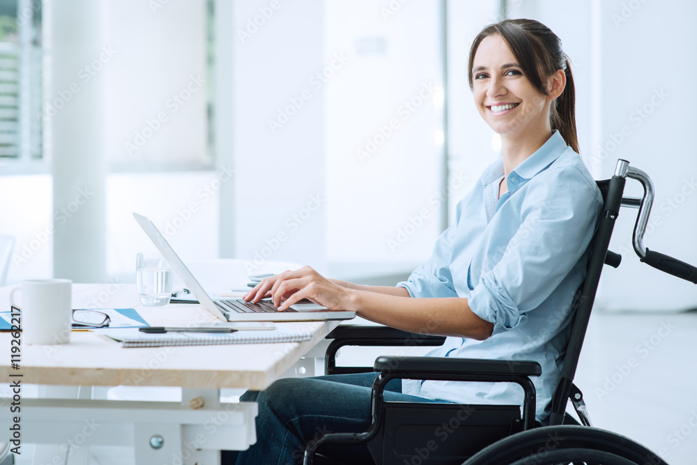 Smiling business woman in wheelchair Smiling business woman in wheelchair
