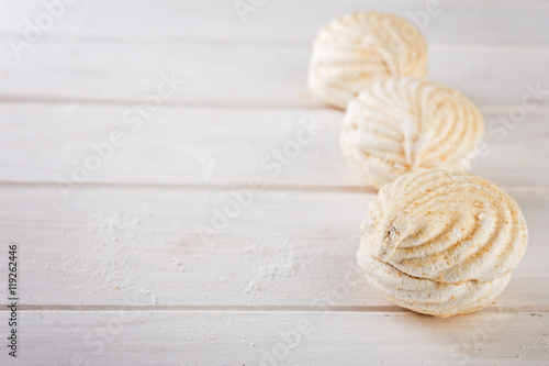  close up sweet zephyrs on white wood background. Bakery products.