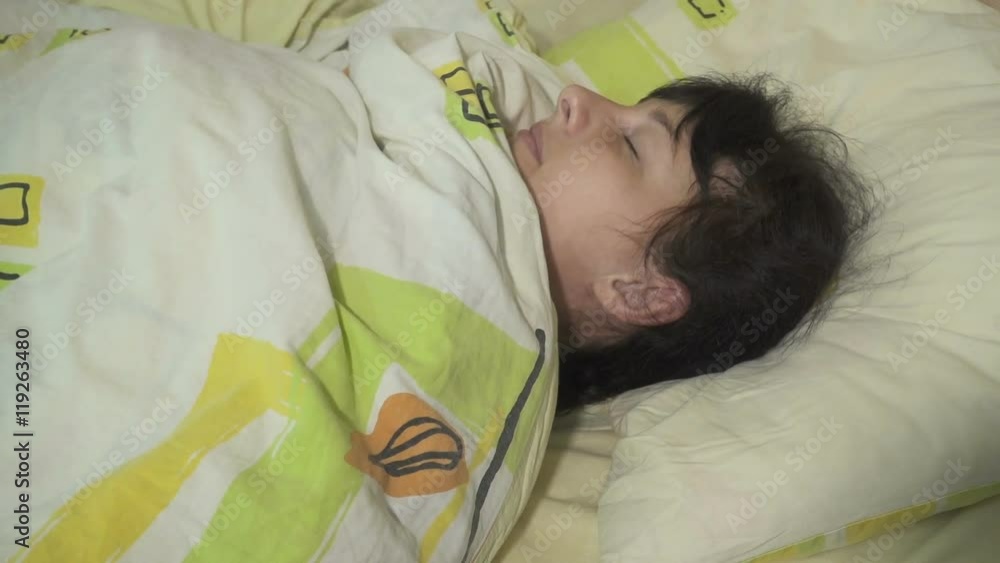 Young women can't fall asleep, tosses and turns. Man closeup suffering