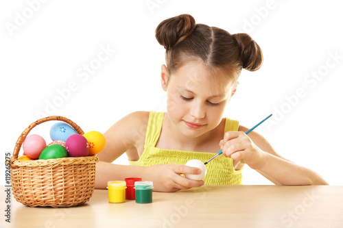Cute girl painting Easter e...