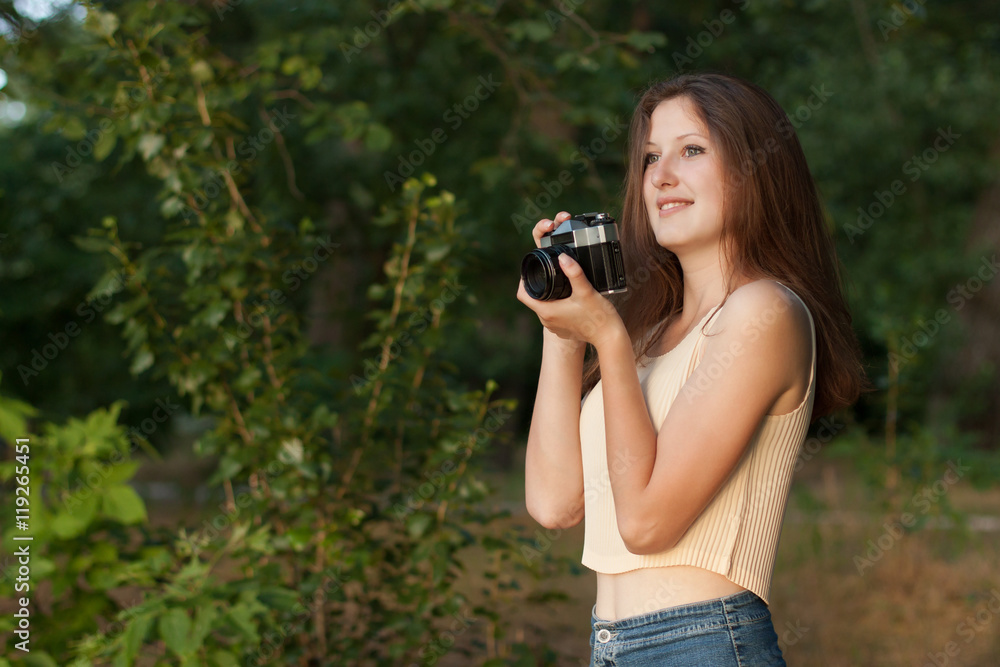 Young girl with retro photo camera