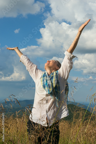 Young woman enjoying life on a mountain meadow