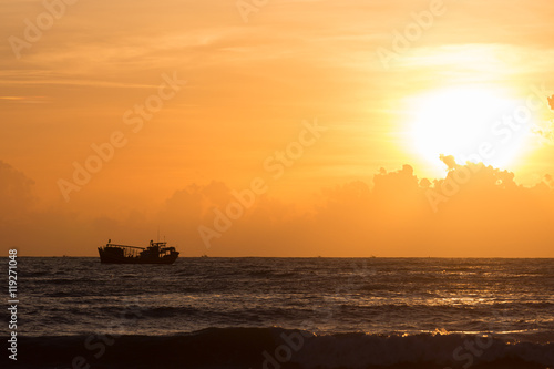 nautical fishing boat in sea with beautiful sky sunrise