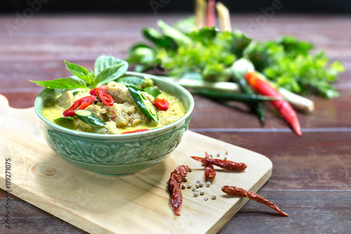 Green curry with fish ball in green chalice on wooden table