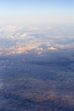 Fluffy clouds over the earth, the landscape. The scenic sky during sunset, the view from the air.