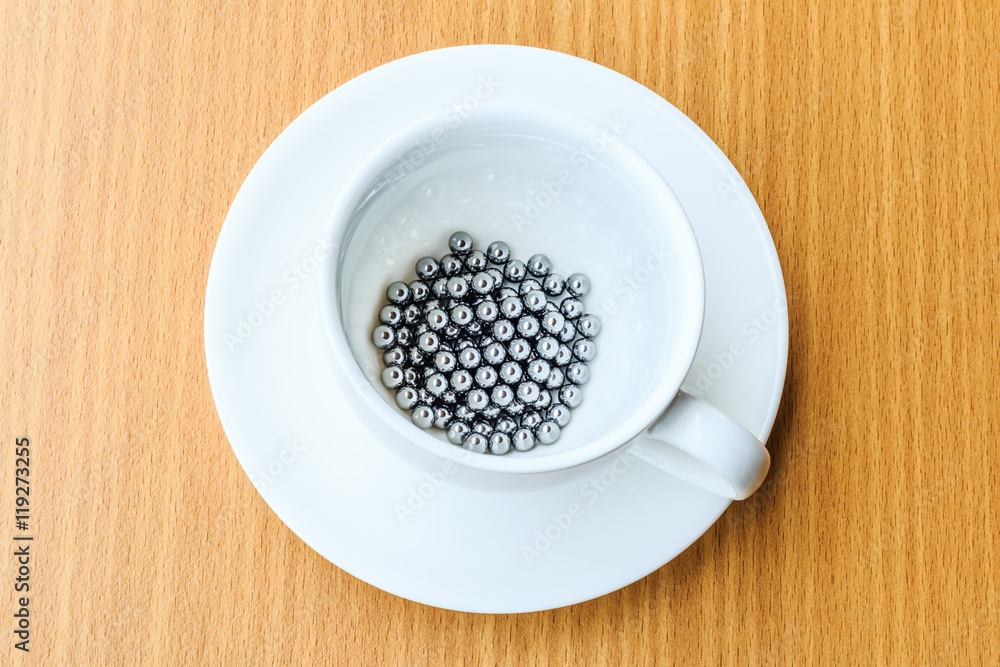 bearings in a dish on wooden table