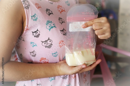 Mother holding milk storage bags, breast feeding bags storage.