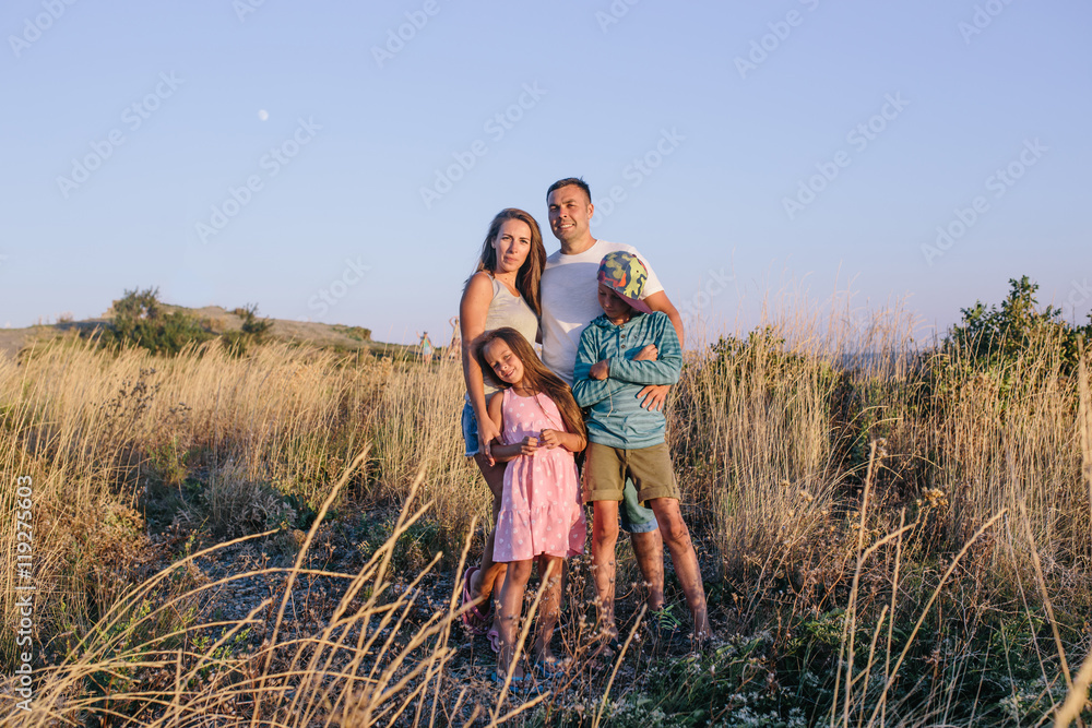 Happy family spending time together outside in field Happy family spending time together outside in field