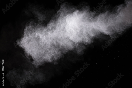Freeze motion of white dust explosions isolated on black background