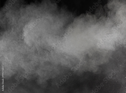 Freeze motion of white dust explosions isolated on black 