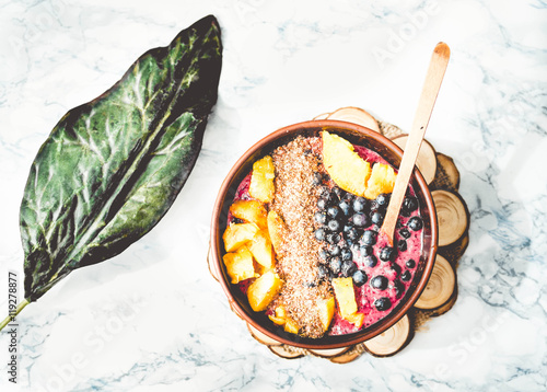 smoothie bowl with peach, blueberry, ground flax and peanut butt