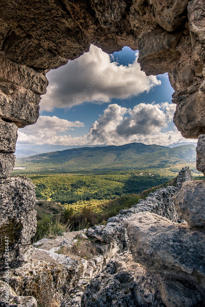 autumn landscape ruined ancient walls on a hill against the blue sky in Crimea