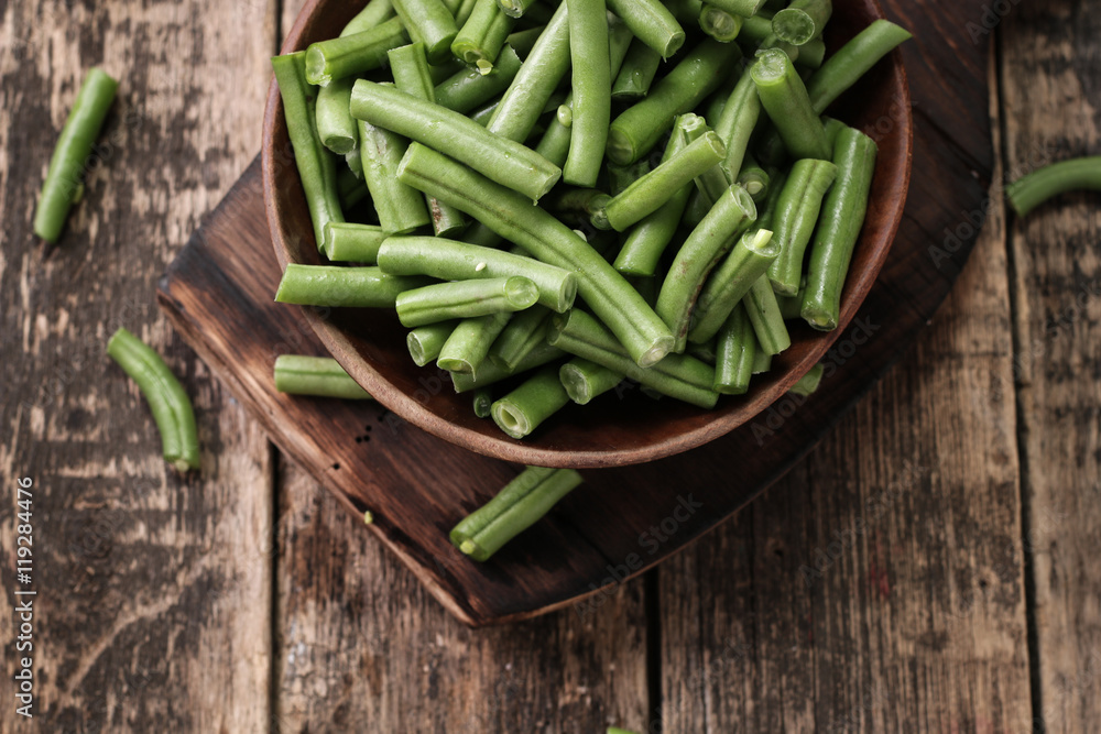 Bunch of freshly picked green beans on a wooden surface. Bunch of freshly picked green beans on a wooden surface.