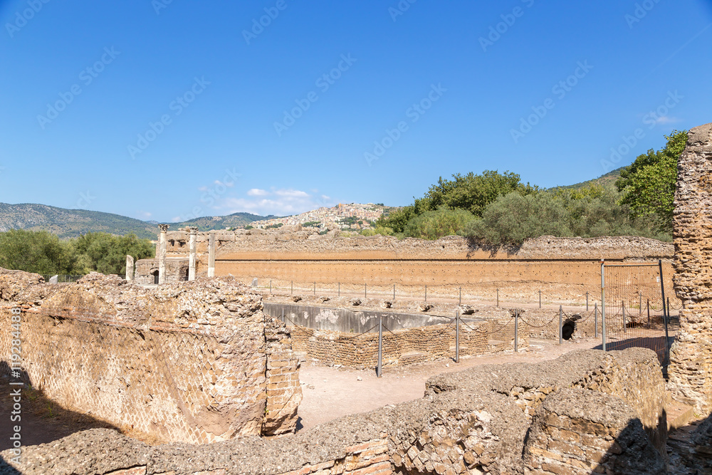 Villa Adriana, Italy. Four-portico surrounding the fish pond (UNESCO list). In the background, a modern city of Tivoli