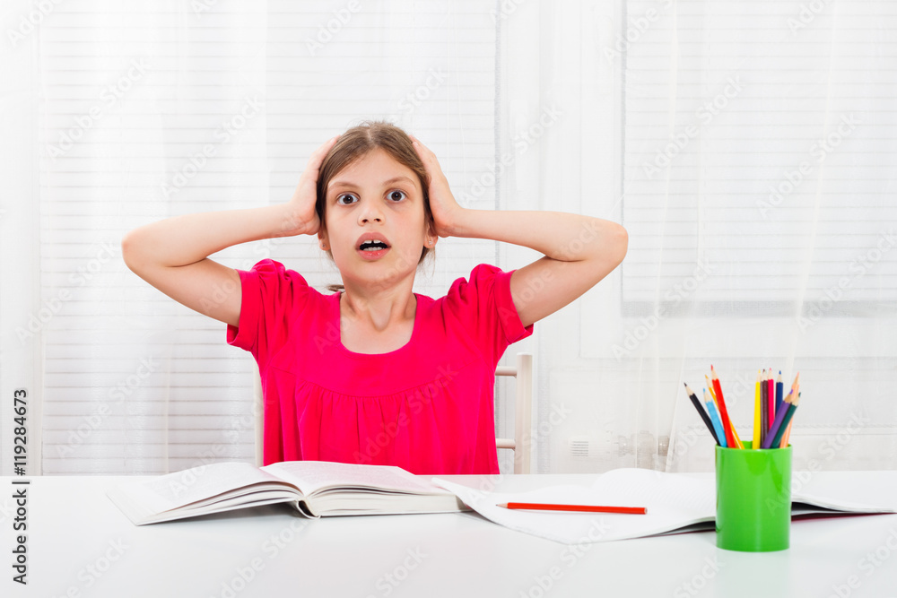Little girl is in panic because of her homework. Little girl is in panic because of her homework.