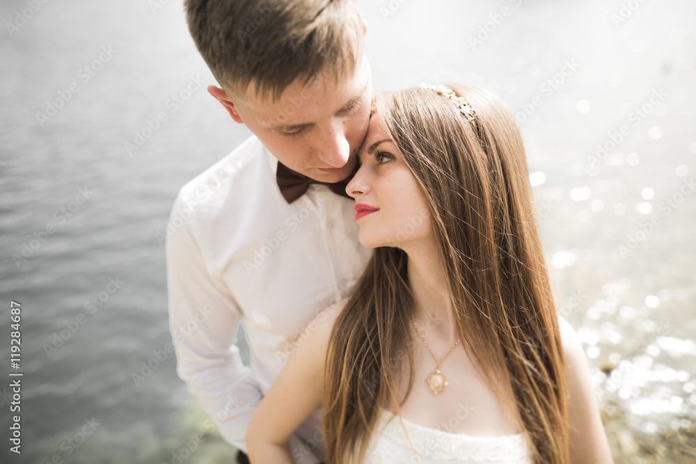 Kissing wedding couple in spring nature close-up portrait