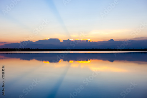 Sunset landscape with blue sky over the calm lake.