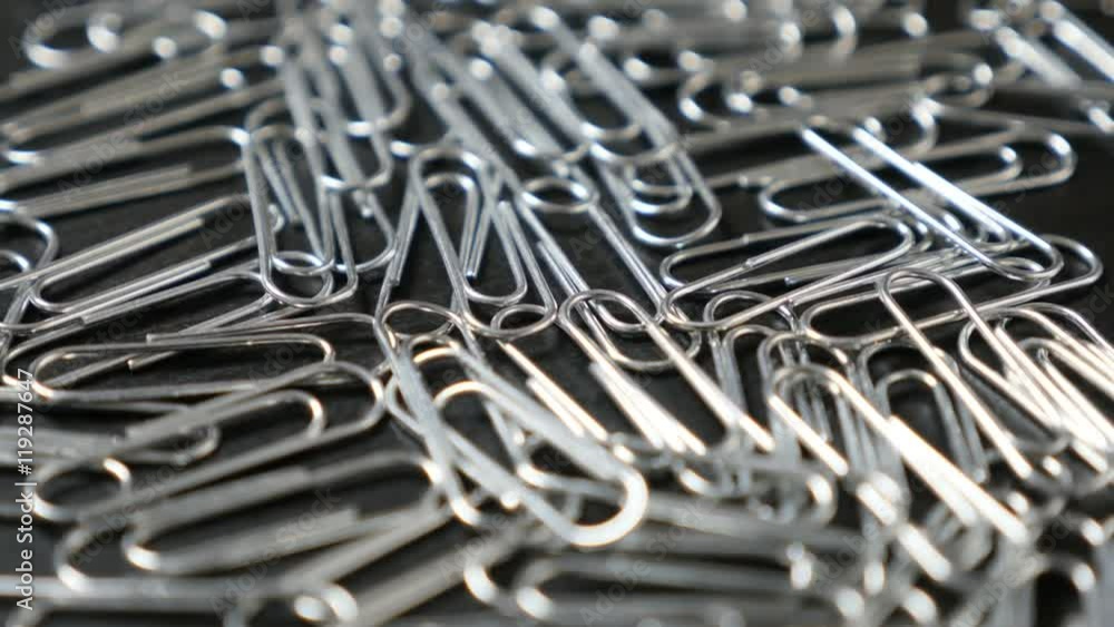 Metal or steel wire clips for documents in office on wooden table close-up slow tilt 4K 2160p 30fps UltraHD footage - Wire steel paperclips with looped shape 4K 3840X2160 UHD tilting video Metal or steel wire clips for documents in office on wooden table close-up slow tilt 4K 2160p 30fps UltraHD footage - Wire steel paperclips with looped shape 4K 3840X2160 UHD tilting video
