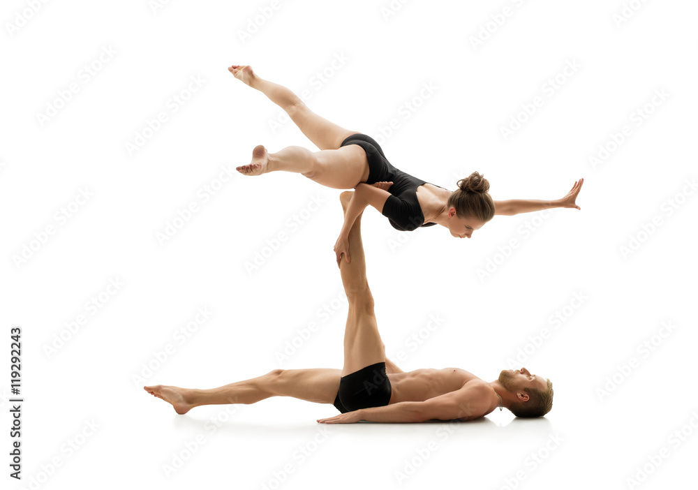 Studio photo of couple practising acrobatics Studio photo of couple practising acrobatics