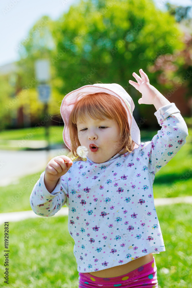 Cute little girl gets dandelion and smiling, happy family having fun  playing outdoor, summer nature