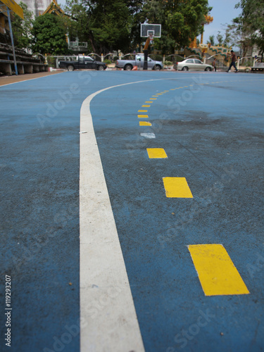 The yellow line on blue floor © tigercat_lpg