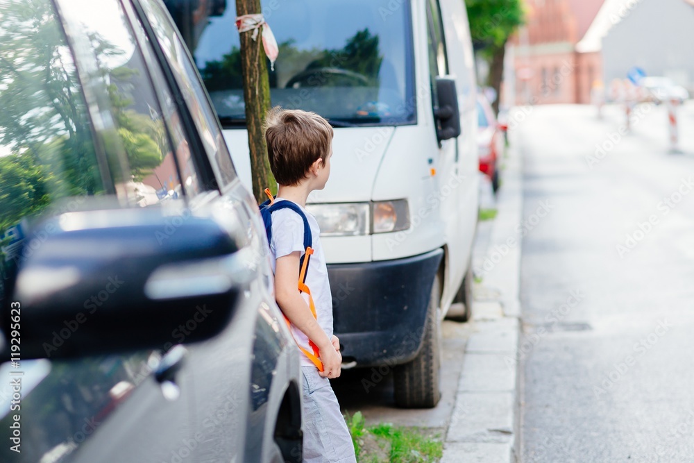 Little 7 years old boy during his road to school.