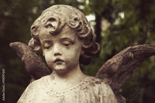 sculpture of an angel with dark background