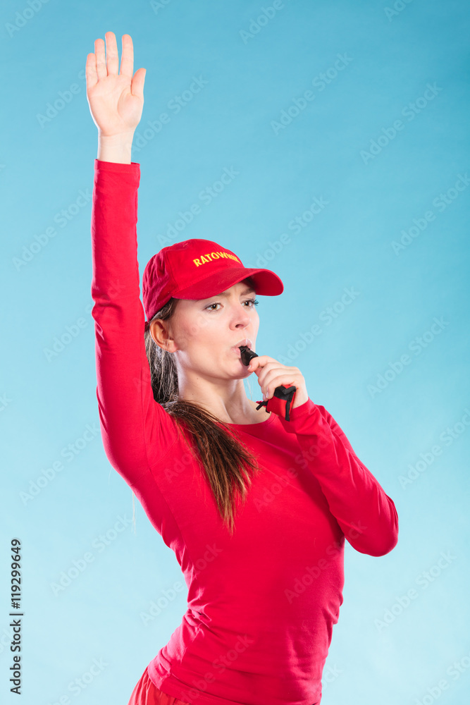 Lifeguard woman in cap on duty blowing whistle. Lifeguard woman in cap on duty blowing whistle.
