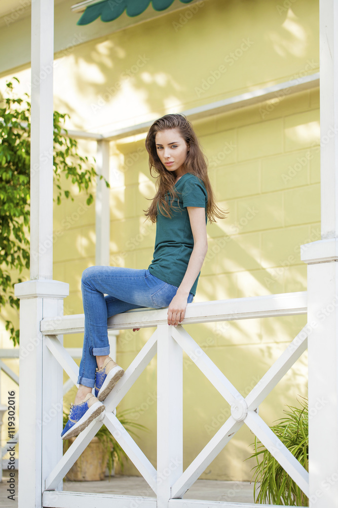 Young beautiful brown haired woman in blue jeans