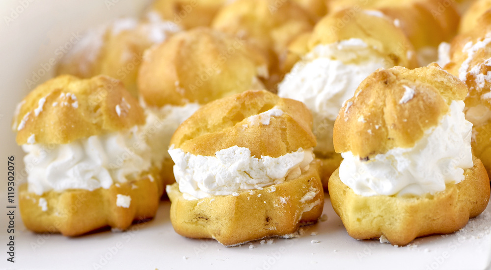 Cream puff cakes with whipped cream in white box