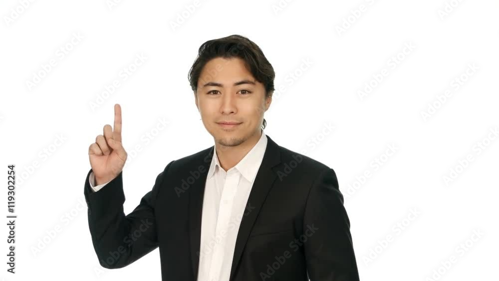A casual good looking businessman walking in front of a white background, stopping and pointing showing with his finger. Shot in 4K on white background. A casual good looking businessman walking in front of a white background, stopping and pointing showing with his finger. Shot in 4K on white background.