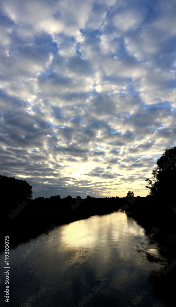 Wolkenband über einem Fluss