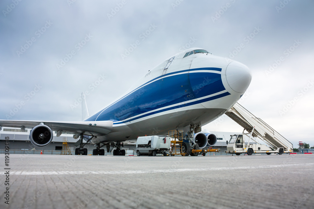 Cargo wide-body plane and aircraft passenger loader near terminal Cargo wide-body plane and aircraft passenger loader near terminal