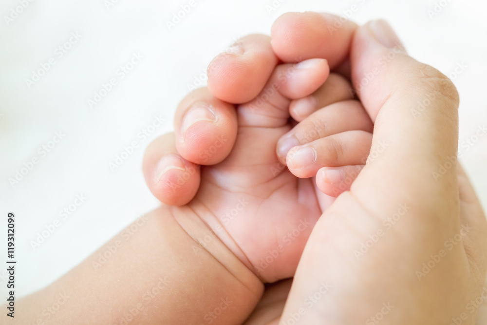 Mather hand holding baby hand on white background. Mather hand holding baby hand on white background.
