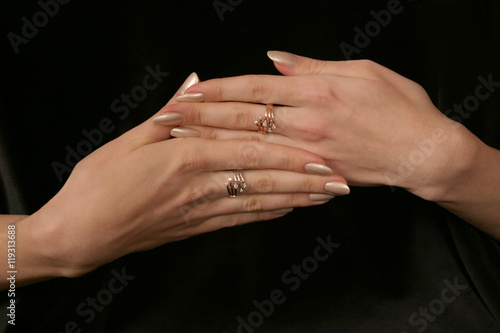 female hand holding fingers diamond ring