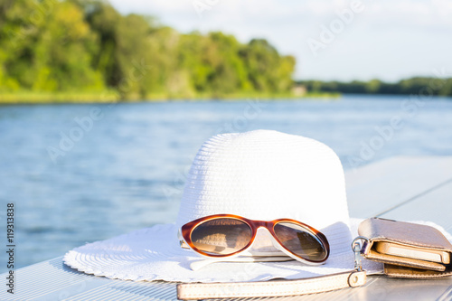 Принти на полотні vacation and technology accessories on lakeside smartphone,  hat