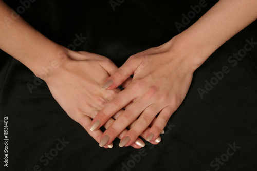 female fingers hands on black