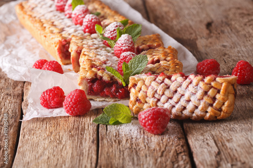 Sweet sliced pie stuffed with ripe raspberry close up. horizontal 