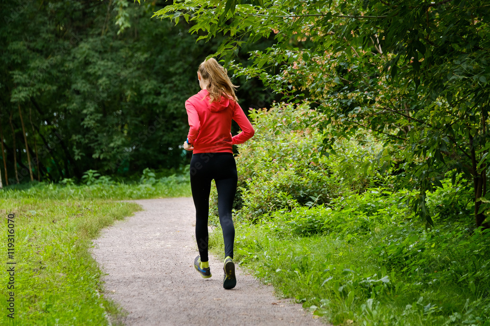 Young slim woman jogging in a park Young slim woman jogging in a park
