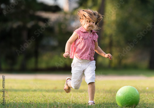 Girl kicking ball © Dusan Kostic