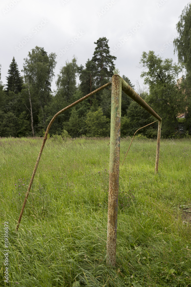 Rusty gate at an abandoned football pitch.