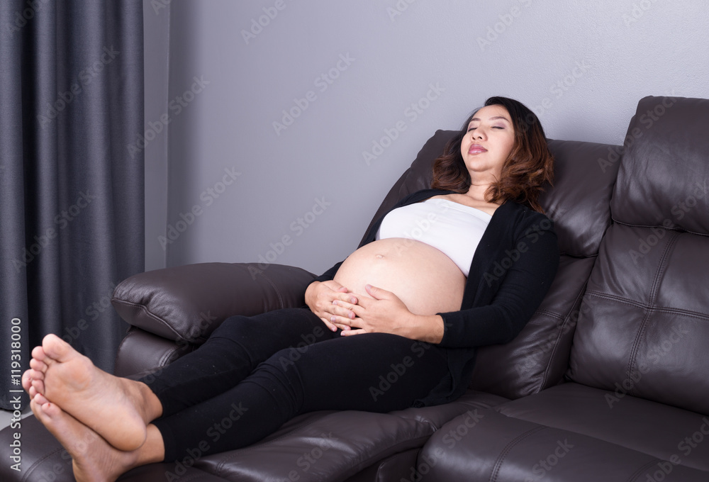 Pregnant woman sleeping on sofa Pregnant woman sleeping on sofa