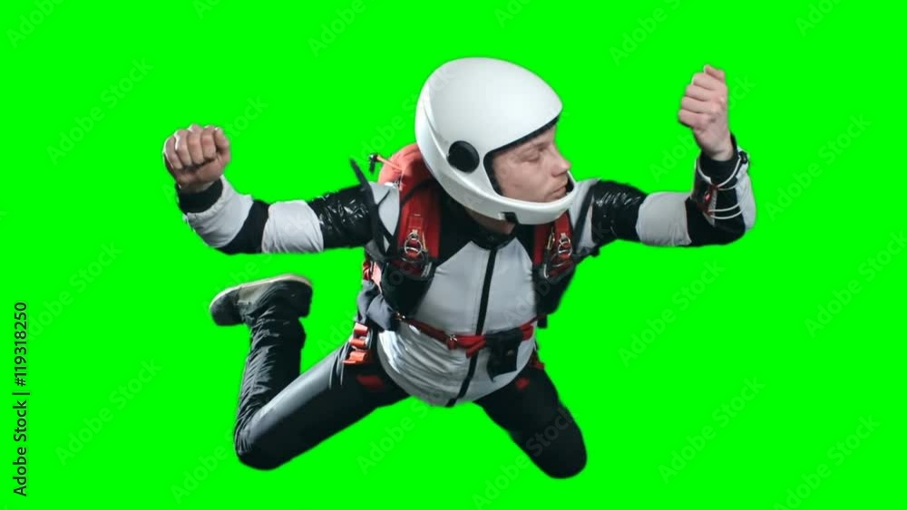 Locked down slow motion shot of calm skydiver looking at altimeter on his wrist and pulling strap on his harness to open parachute, then coming out of frame as chute pulls him up, chroma key Locked down slow motion shot of calm skydiver looking at altimeter on his wrist and pulling strap on his harness to open parachute, then coming out of frame as chute pulls him up, chroma key