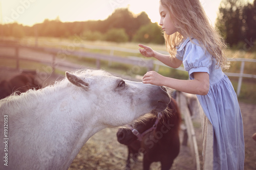 young girl have fun on a horse farm